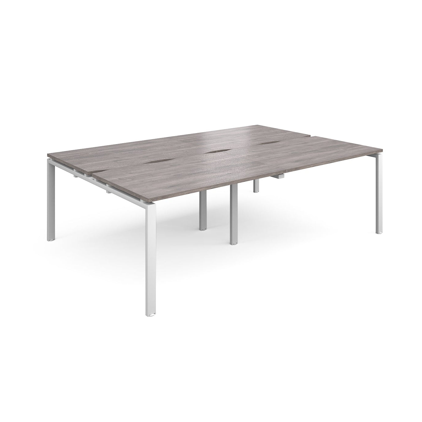 Large modular bench desk with a grey wood-effect top, integrated cable access slots, and white metal legs, shown on a white background.