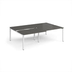 Large modular bench desk with a dark grey worktop, integrated cable access cut-outs, and white metal legs, shown on a white background.