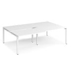 Large modular bench desk with a white worktop, integrated cable access cut-outs, and white metal legs, shown on a white background.