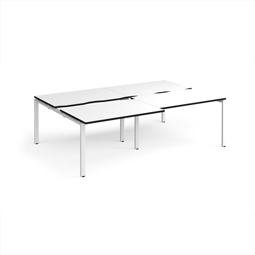 Large modular bench desk with a white worktop, contrasting black edge detail, integrated cable access cut-outs, and white metal legs, shown on a white background.