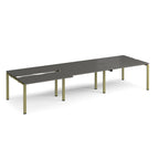 Large modular bench desk with a dark grey worktop, integrated cable access cut-outs, and green metal legs, shown on a white background.