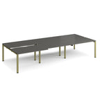 Large modular bench desk with a dark grey worktop, integrated cable access cut-outs, and green metal legs, shown on a white background.