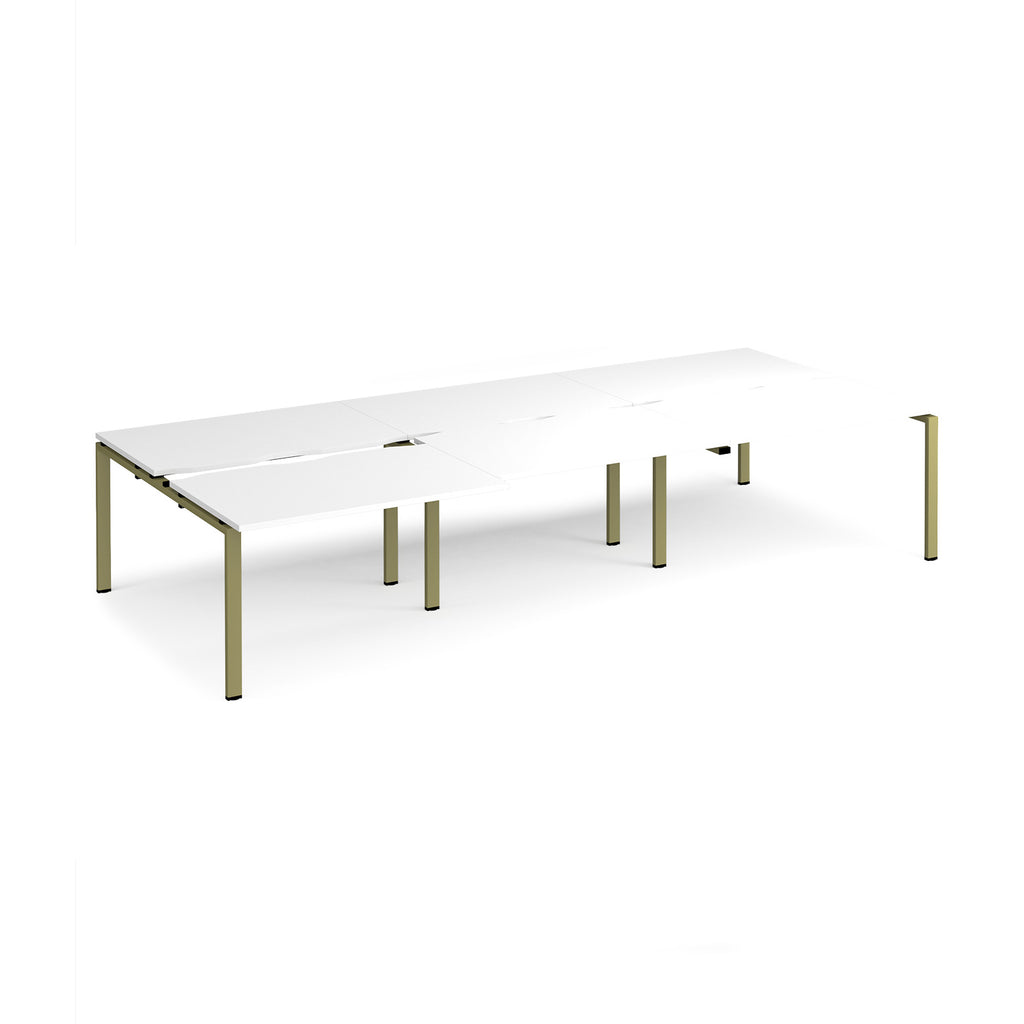 Large modular bench desk with a white worktop, integrated cable access cut-outs, and green metal legs, shown on a white background.