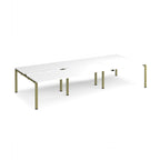 Large modular bench desk with a white worktop, integrated cable access cut-outs, and green metal legs, shown on a white background.