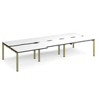 Large modular bench desk with a white worktop, contrasting black edge detail, integrated cable access cut-outs, and green metal legs, shown on a white background.