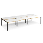 Large modular bench desk with white panels and wood-effect edging, integrated cable access cut-outs, and black metal legs, shown on a white background.