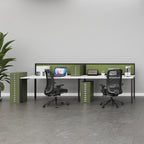 A modern two-person office desk setup with a white desk surface, olive green privacy dividers and storage cabinets, and two black mesh office chairs in a bright, minimalist office space.
