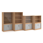 Range of wood-effect office storage cupboards with open shelving and lockable tambour doors, shown in different sizes on a white background.