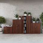 A set of modern wooden office storage cabinets in a warm brown finish, arranged against a textured grey concrete wall with potted plants and books as styling props.
