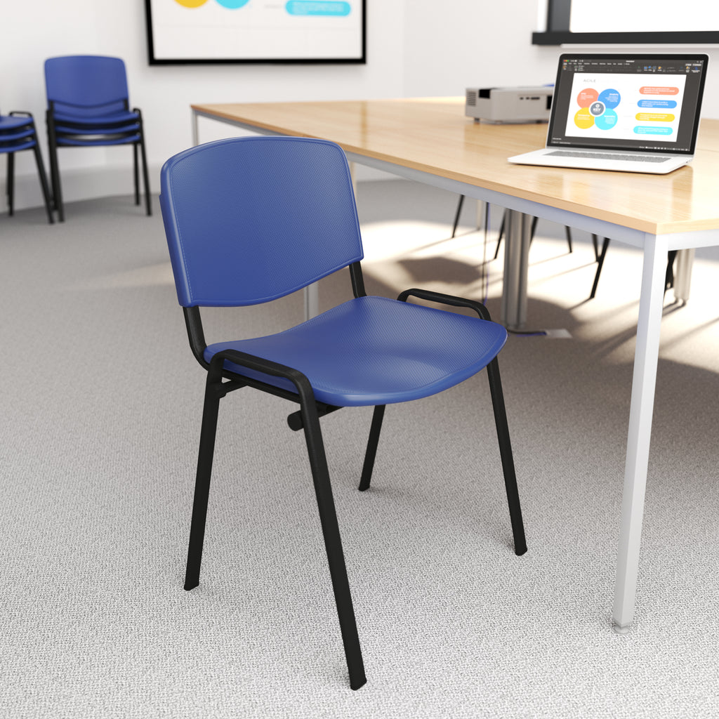 Blue chair with black legs in a room with tables and a laptop.