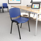 Blue chair with black legs in a room with tables and a laptop.