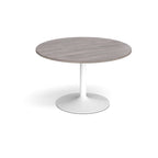 Round table with wood-effect top and white base on a white background