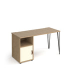 Home office desk with a wood-effect tabletop, integrated storage unit with open shelf and white door, and slim black hairpin legs, shown on a white background.

