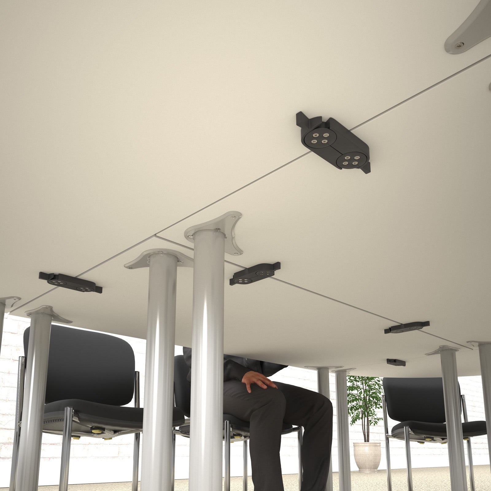 Under table with linking devices with person and chairs in the background