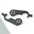 Black metal bracket with circular components on a white surface