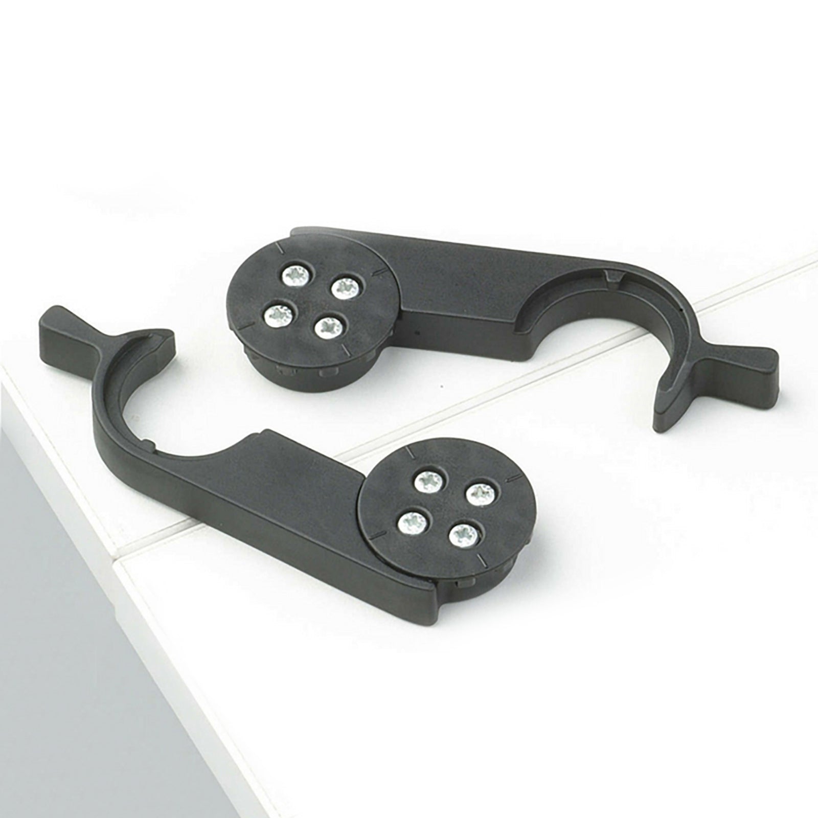 Black metal bracket with circular components on a white surface