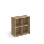 Wooden office storage unit with four open cubby compartments, rectangular design, and small adjustable feet, shown on a white background.