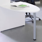 Close-up of a white reception desk with a curved countertop and chrome support leg, shown with a notebook and office chair in the background.