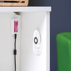 White electronic device with a power cable attached to a white surface.