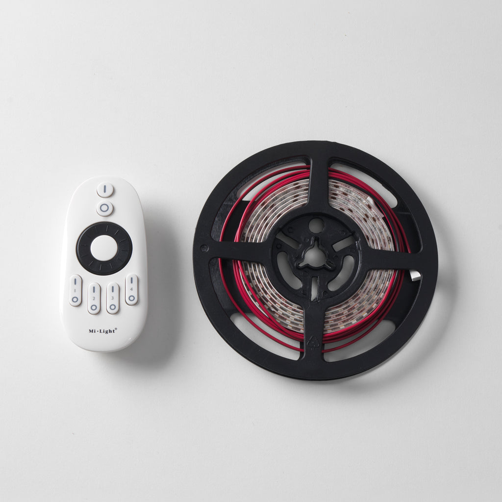 LED strip light on a reel with a remote control on a white background