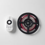 LED strip light on a reel with a remote control on a white background