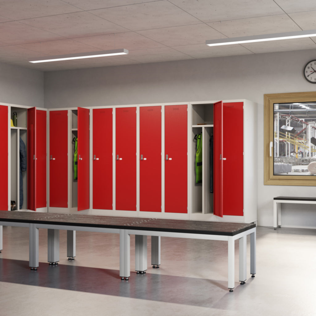 Red lockers with benches in a locker room setting