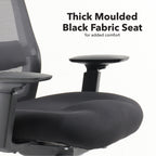 Close-up of an office chair showing a thick moulded black fabric seat designed for added comfort, with armrest and mesh back visible.
