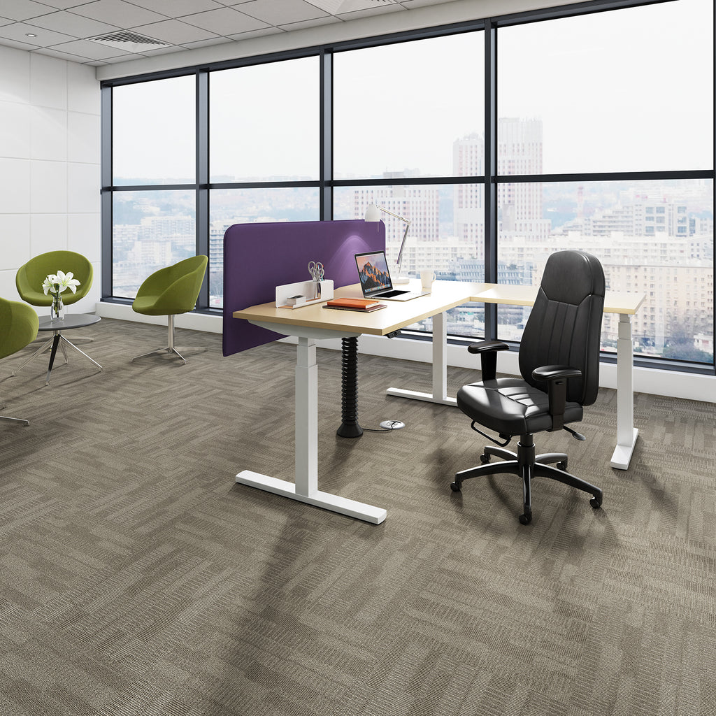 Modern office setup with a desk, chair, and green chairs in front of large windows.